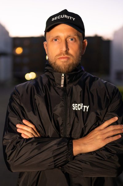 Portrait Of Young Male Security Guard Standing Arms Crossed Portrait Of Young Male Security Guard Standing Arms Crossed
